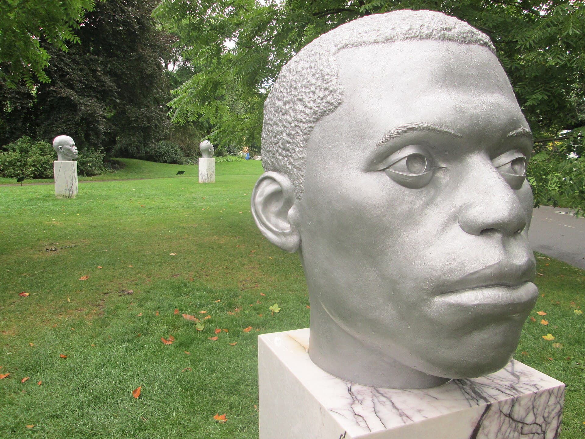 Aluminium heads on marble plinths in the English Gardens of The Regent's Park, London, during Frieze Sculpture 2017.